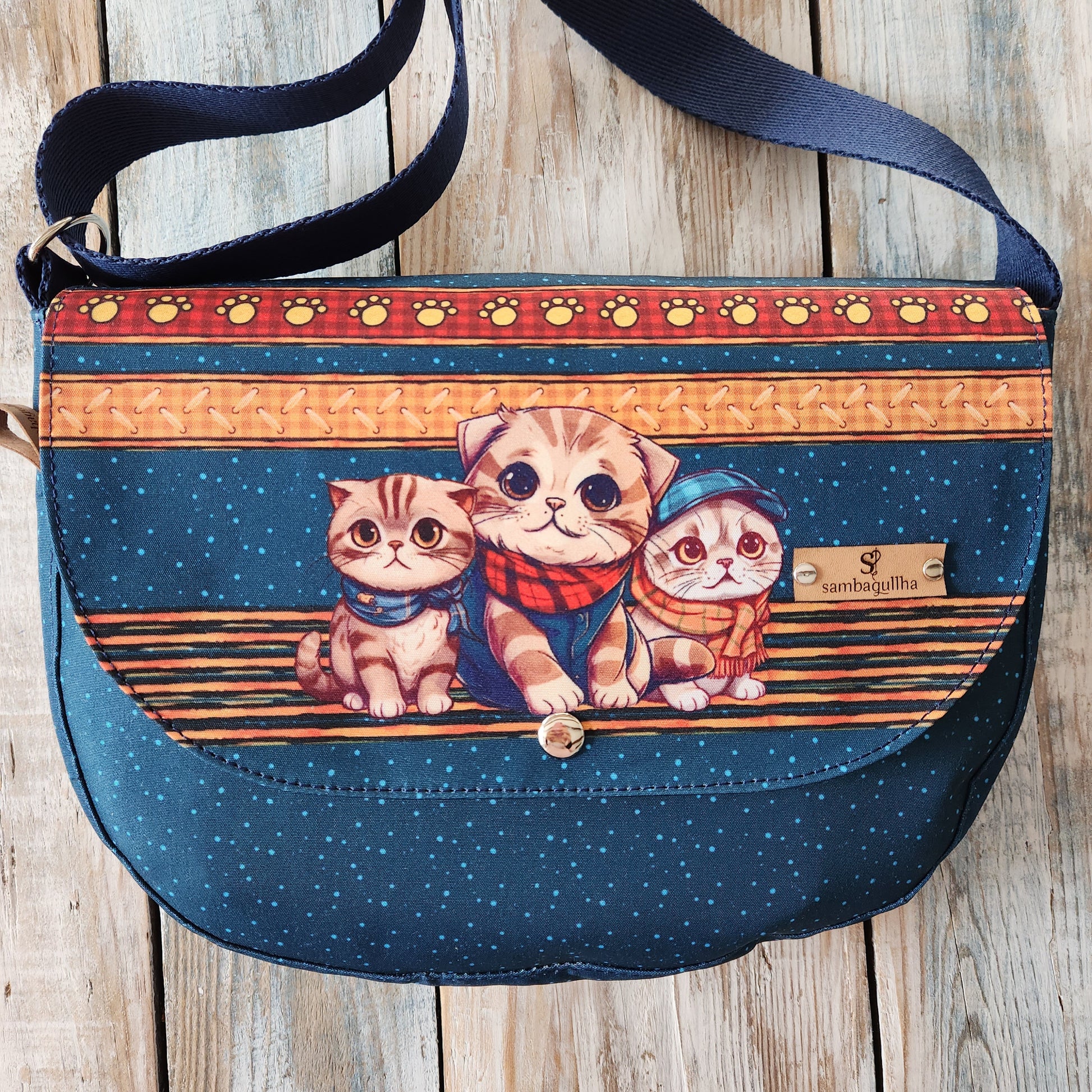 Crossbody bag with cat designs.