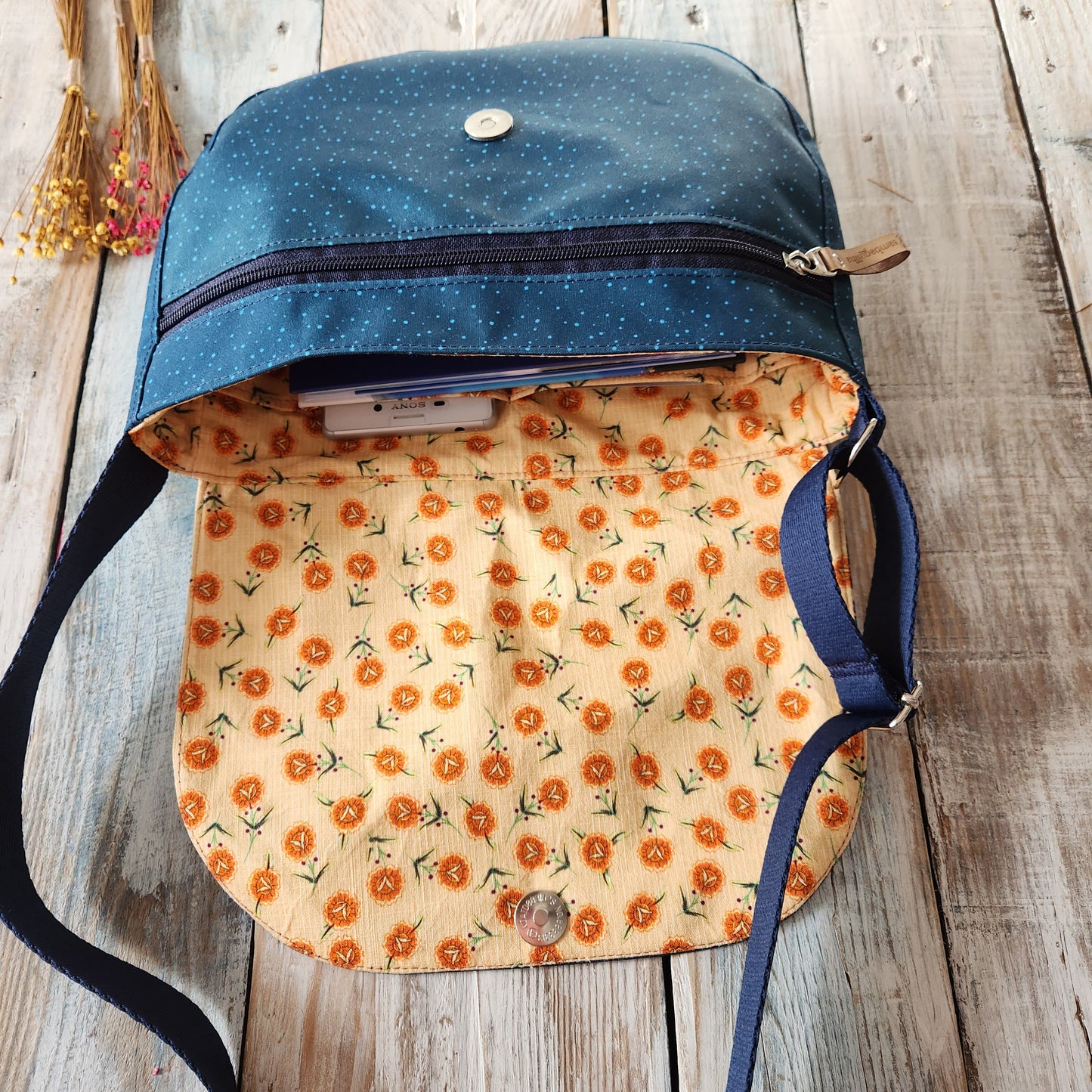 Crossbody bag with cat designs.