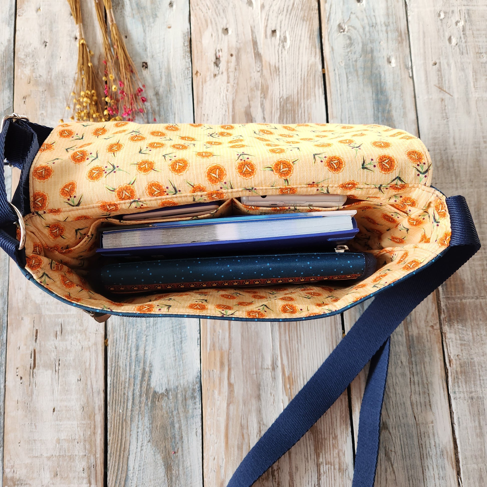 Crossbody bag with cat designs.
