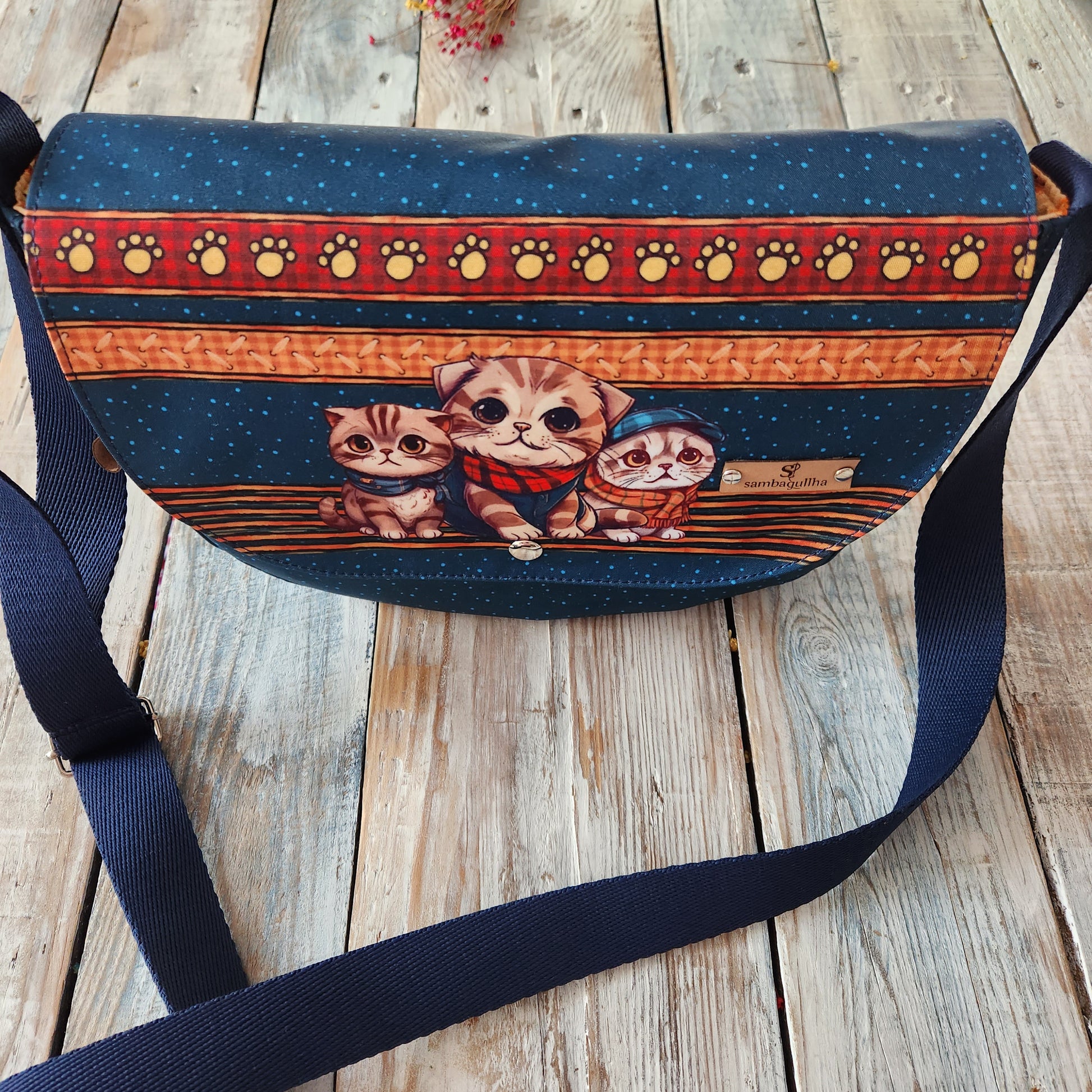 Crossbody bag with cat designs.